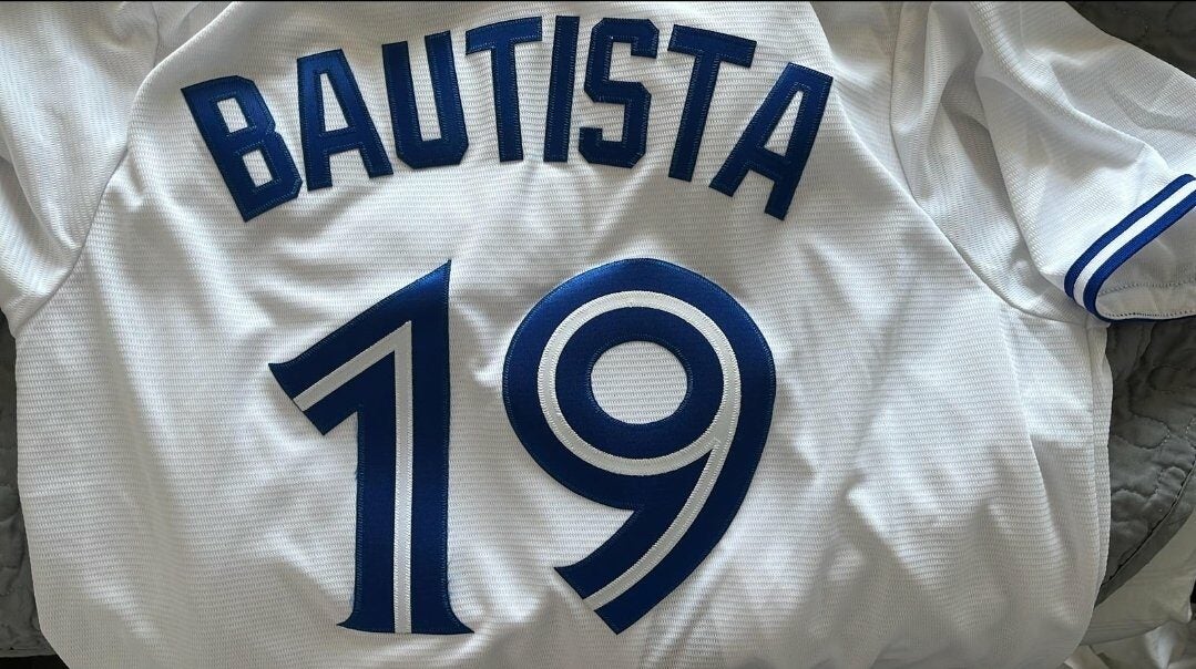 Male vendor in Red Blue Jays Jersey on Canada Day weekend selling